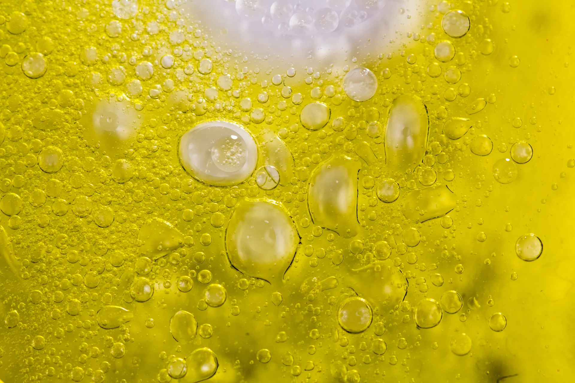 Golden olive oil texture with bubbles