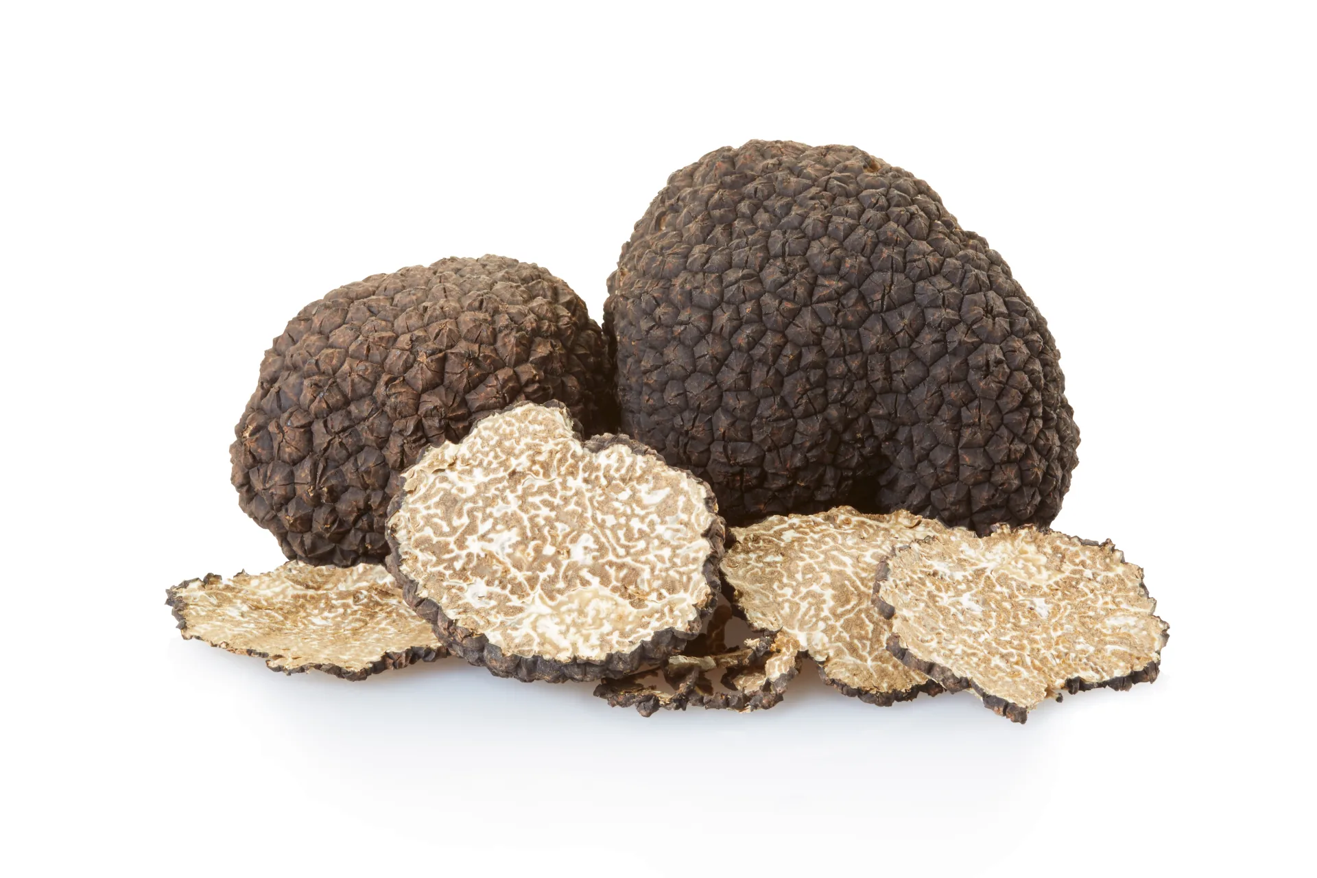 Thin truffle slices on a white surface